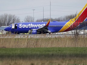 A Southwest Airlines plane sits on the runway at the Philadelphia International Airport after it made an emergency landing in Philadelphia, on Tuesday, April 17, 2018.