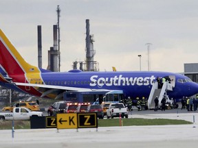 A Southwest Airlines plane sits on the runway at the Philadelphia International Airport after it made an emergency landing in Philadelphia, on Tuesday, April 17, 2018.