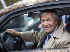 FILE - In this Oct.8, 2014 file photo, France's Vincent Bollore, head of the Bollore Group, sits in a customized Autolib electric car in Paris. French billionaire Vincent Bollore has been detained for questioning in an investigation into alleged corruption in lucrative port deals in Africa. French newspaper Le Monde says the investigation focuses on suspicions around port deals in 2010 in Lome, the capital of the West African nation of Togo, and Conakry in Guinea.