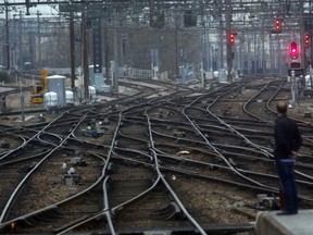 A man stands on a platform during strike action at the Gare Saint Lazare train station in Paris, France, Monday, April 9, 2018. Unions are planning periodic two-day strikes through June to try to counter the French government's plans to abolish a benefits system that allows train drivers and other workers to have jobs for life.