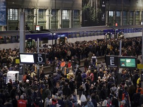 Passengers and commuters wait at rush hour at Gare de Lyon train station, in Paris, France, as union stage a mass strike, Tuesday, April 3, 2018. French unions plan strikes two days every week through June to protest government plans to eliminate some rail worker benefits -- part of broader European plans to open national railways to competition.