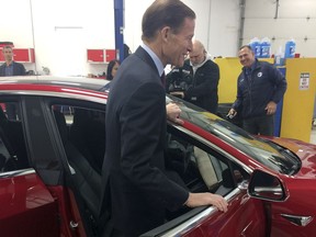 CORRECTS TO MODEL 3-U.S. Sen. Richard Blumenthal, D-Conn., climbs into a Tesla Model 3 at the Consumer Reports Test Track, Tuesday, April 3, 2018, in Colchester, Conn. The senator said he thinks more safeguards should be added to a bill that is before the Senate that would gradually introduce self-driving cars in the U.S. Among other things, he wants cars with autopilot systems like the Tesla, the same model involved in last month's fatal accident, to be included under the bill.