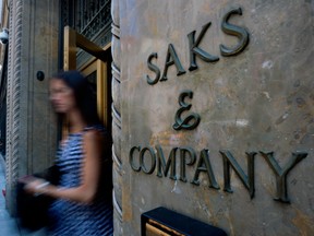 A shopper uses a Fifth Avenue entrance to Saks, in New York. A data breach at department store chains Saks Fifth Avenue, Saks Off Fifth and Lord & Taylor has compromised the personal information of customers who shopped at the stores.