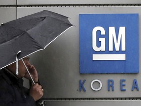 A worker of GM Korea talks on the mobile phone at GM Korea's factory in Bupyeong, South Korea, Monday, April 23, 2018. General Motors says it has reached a tentative agreement with its South Korean labor union to a set of measures to cut costs and allocate new car models to existing GM Korea factories.