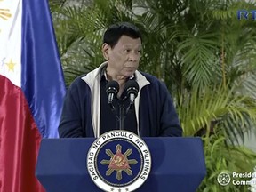 In this image from video, Philippine President Rodrigo Duterte answers a reporter's question in Davao, Philippines, Sunday, April 29, 2018. Duterte said that a ban on Filipino workers from heading to Kuwait that's been in effect since February would now be permanent, inflaming a dispute sparked by complaints of the abuse of Filipina housemaids and workers in the Gulf country. Kuwait on Wednesday expelled the Philippine ambassador and recalled its own envoy from Manila over the dispute.(RTVM via AP)