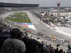 Drivers head into Turn 1 after a restart during a NASCAR Cup Series auto race in Fort Worth, Texas, Sunday, April 8, 2018.