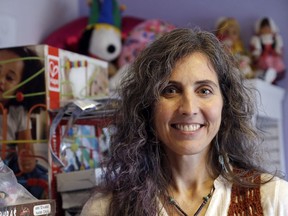 In this Friday, April 6, 2018, photo, Adrienne Kosewicz, owner of Play It Safe World Toys, poses for a portrait in her home office in Seattle. Kosewicz pays $3,600 a year for tax collection software to handle payments and reports to her home state, Washington. Her Seattle-based online business sells through Amazon, which handles computation and collection.