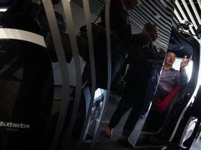 Volkswagen Group Chief Digital Officer Johann Jungwirth sits inside a Volkswagen Sedric, a self-driving concept pod, while introducing the vehicle ahead of the Auto China 2018 at the Volkswagen Future Center Asia office in Beijing, Tuesday, April 24, 2018. Auto China 2018, the global industry's biggest sales event, will start on Wednesday.