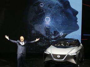 Chen Hao, Dongfeng Nissan Passenger Vehicle company's deputy managing director gestures near the Nissan IMX concept car during the start of the Auto China 2018 in Beijing, China, Wednesday, April 25, 2018. Volkswagen and Nissan have unveiled electric cars designed for China at the Beijing auto show that highlights the growing importance of Chinese buyers for a technology seen as a key part of the global industry's future.