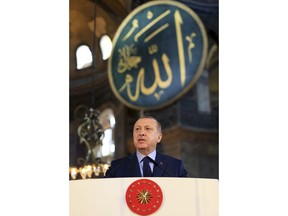 Turkey's President Recep Tayyip Erdogan, delivers a speech during an arts biennial opening inside the Byzantine-era Hagia Sophia, an UNESCO world heritage site and one of Istanbul's main tourist attractions, in the historic Sultanahmet district of Istanbul, Saturday, March 31, 2018. Turkey's president has recited an Islamic prayer in the Hagia Sophia, an Istanbul landmark that has become a symbol of interfaith and diplomatic tensions. Erdogan recited the Quran's first verse to the "souls of all, especially Istanbul's conqueror."