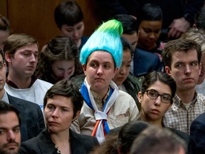 A audience member wearing a blue and green pointy wig, aiming to look like a Russian troll as Facebook CEO Mark Zuckerberg testifies before a joint hearing of the Commerce and Judiciary Committees on Capitol Hill in Washington, Tuesday, April 10, 2018.