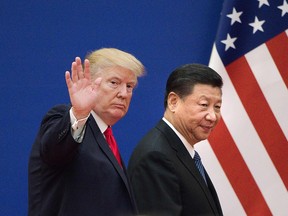 This file picture taken on November 9, 2017 shows U.S. President Donald Trump and China's President Xi Jinping leaving a business leaders event at the Great Hall of the People in Beijing.