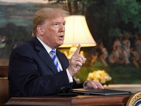 U.S .President Donald Trump speaks to the press after signing a document reinstating sanctions against Iran after announcing the US withdrawal from the Iran Nuclear deal, in the Diplomatic Reception Room at the White House in Washington, D.C., on May 8, 2018.