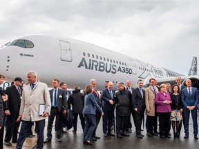 German Chancellor Angela Merkel (4th from R) and Airbus CEO Thomas Enders (2nd from R) pose in front of an Airbus A350 aircraft at the ILA Berlin International Aerospace Exhibition at Schoenefeld airport near Berlin on April 25, 2018.