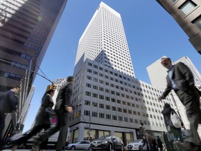 People walk near the 666 Fifth Avenue skyscraper, center, owned by the Kushner Cos., Wednesday, March 29, 2017, in New York.