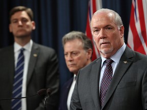 Premier John Horgan, Attorney General David Eby and Environment Minister George Heyman meet with media to discuss filing a court case regarding oil jurisdiction in B.C. during a press conference in the press theatre at Legislature in Victoria, B.C., on Thursday April 26, 2018.