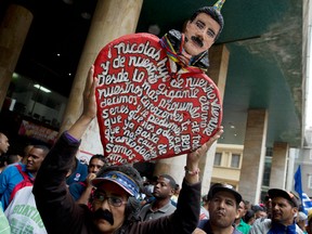A supporter of Venezuela's President Nicolas Maduro stands outside the government-controlled National Electoral Council in Caracas, Venezuela.