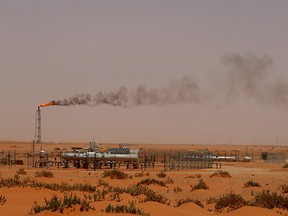 flame from a Saudi Aramco oil installion known as "Pump 3" is seen in the desert near the oil-rich area of Khouris.