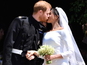Britain's Prince Harry and his wife Meghan Markle kiss after their wedding ceremony at St. George's Chapel in Windsor Castle in Windsor, near London, England, Saturday, May 19, 2018.