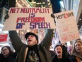Demonstrators rally in support of net neutrality outside a Verizon store, Thursday, Dec. 7, 2017, in New York. The House of Commons standing committee, oblivious to economic fundamentals, has recommended that net neutrality be imbedded in Canadian law.