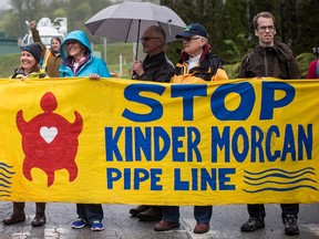 Protesters opposed to the Kinder Morgan Trans Mountain Pipeline expansion prevent a truck from leaving the company's facility, in Burnaby, B.C., on Saturday April 28, 2018.