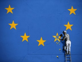 A recently painted mural by British graffiti artist Banksy, depicting a workman chipping away at one of the stars on a European Union (EU) themed flag, is pictured in Dover, south east England on May 8, 2017.