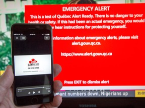 A smartphone and a television receive visual and audio alerts to test Alert Ready, a national public alert system.
