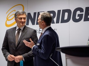 Enbridge president and CEO Al Monaco, left, speaks with director Gregory Ebel before addressing the company's annual meeting in Calgary, May 9, 2018