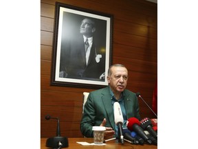 Turkey's President Recep Tayyip Erdogan speaks to the media at Ataturk Airport before his departure for London for a two-day official visit, in Istanbul, Sunday, May 13, 2018.(Presidential Press Service/Pool via AP)