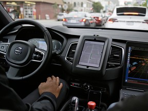 An Uber driverless car waits in traffic during a test drive in San Francisco.