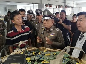 In this photo taken Thursday, May 24, 2018, and released by the Royal Thai Police, a factory processing electronic waste is visited by police in Lat Krabang, outside Bangkok, Thailand. Police have raided several factories near Bangkok that allegedly were processing illegally imported electronic waste in a sign that China's crackdown on waste recycling is pushing such operations offshore. (Royal Thai Police via AP)