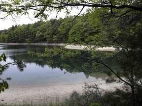 FILE - This May 23, 2017, file photo shows a view of Walden Pond in Concord, Mass., where the 19th century American philosopher and naturalist Henry David Thoreau spent two years in solitude and reflection. A new Playstation game devoted to the Thoreau classic debuts on Tuesday, May 15, 2018.