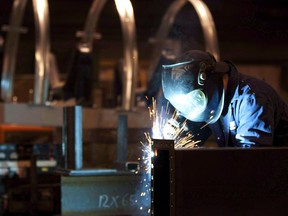 A welder works in a factory in Quebec City, Tuesday, February 28, 2012. Statistics Canada says manufacturing sales rose 1.4 per cent to $57.1 billion in March, with gains in 72 per cent of the industries monitored.THE CANADIAN PRESS/Jacques Boissinot