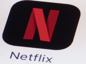 The Netflix logo on an iPhone in Philadelphia on Monday, July 17, 2017. Online giants like Netflix and Spotify should be forced to open their wallets to create local content before Canadians sees losses of jobs, services and content, the country's broadcast regulator says.
