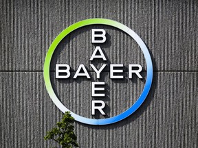 The Bayer AG corporate logo is displayed on a building of the German drug and chemicals company in Berlin, Germany on May 23, 2016. The Competiton Bureau is forcing Bayer AG to divests its canola, soybean and vegetable seed, traits and herbicide assets before it will allow the German pharmaceutical giant to purchase agricultural business Monsanto Company.