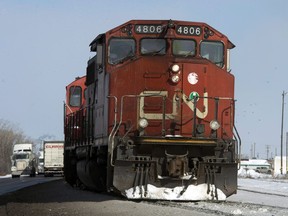 Canadian National locomotives are seen Monday, February 23, 2015 in Montreal. Canadian National Railway Co. says it plans to acquire 1,000 new grain hopper cars over the next two years that will allow it to phase out older, lower-capacity cars.