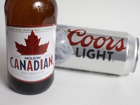 A bottle of Molson Canadian beer and a can of Coors Light are shown in this Nov. 28, 2017 in Walpole, Mass.