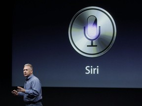 Apple's Phil Schiller talks about Siri with the new Apple iPhone 4S during an announcement at Apple headquarters in Cupertino, Calif., Tuesday, Oct. 4, 2011. In the heated battle between Amazon, Apple, Google and Microsoft to get consumers hooked on their virtual assistants, Siri seems to be enjoying the first-mover advantage.THE CANADIAN PRESS/AP, Paul Sakuma