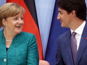 German Chancellor Angela Merkel talks with Canadian Prime Minister Justin Trudeau during the Women's Entrepreneurship Finance event at the G20 Summit, in Hamburg, Germany, Saturday, July 8, 2017.