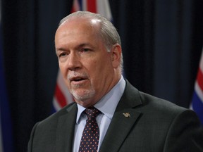 Premier John Horgan, Attorney General David Eby and Environment Minister George Heyman meet with media to discuss filing a court case regarding oil jurisdiction in B.C. during a press conference in the press theatre at Legislature in Victoria on April 26, 2018.