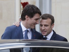 Canadian Prime Minister Justin Trudeau, left, says goodbye to French President Emmanuel Macron after a meeting at the Elysee Palace in Paris, Monday, April 16, 2018. Macron is scheduled to meet Trudeau next week in Ottawa before they sit down with their G7 counterparts for the leaders' summit in La Malbaie, Que.