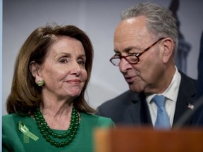 Senate Minority Leader Sen. Chuck Schumer of N.Y., right, and House Minority Leader Nancy Pelosi of Calif., left, speak together during a news conference on Capitol Hill in Washington, Wednesday, May 16, 2018, after the Senate passes a resolution to reverse the FCC decision to end net neutrality.