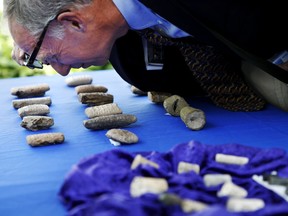 John Russell, an expert on Iraqi antiquities, looks at cuneiform tablets that are being returned to Iraq by Immigration and Customs Enforcement (ICE), during a ceremony at the Residence of the Iraqi Ambassador to the United States, in Washington, Wednesday, May 2, 2018. The artifacts were smuggled into the United States in violation of federal law and shipped to Hobby Lobby stores, a nationwide arts-and-crafts retailer. The shipping labels on these packages falsely described the cuneiform tablets as tile samples.