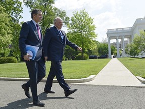 Association of Global Automakers President and Chief Executive Officer John Bozzella, left, and Ford Motor Company Chief Executive Officer Jim Hackett, right, arrive for a meeting with President Donald Trump at the White House in Washington, Friday, May 11, 2018.