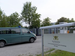 A police van used to transport prisoners stands in front of a migrant shelter in Ellwangen, southern Germany, Thursday, May 3, 2018. Hundreds of police officers have raided a migrant shelter  after authorities were prevented from deporting a 23-year-old man from Togo days ago.