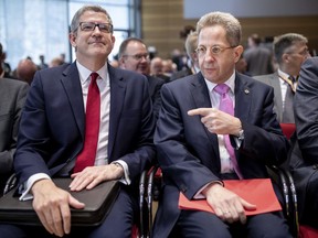 Hans-Georg Maassen, head of the German Federal Office for the Protection of the Constitution, right, talks MI5 head Andrew Parker during symposium on hybrid threat scenarios in Berlin Monday, May 14, 2018.