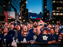 Fans at Maple Leaf Square in Toronto cheer their team.