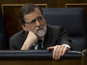 Spain's Prime Minister Mariano Rajoy and Popular Party leader listens to speeches during the first day of a motion of no confidence session at the Spanish parliament in Madrid, Thursday, May 31, 2018. The lower house of the Spanish parliament is debating whether to end Prime Minister Mariano Rajoy's close to eight years in power and supplant him with the leader of the Socialist opposition.