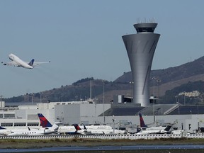 FILE - In this Oct. 24, 2017, file photo, the air traffic control tower is in sight as a plane takes off from San Francisco International Airport in San Francisco. Federal authorities have determined most of the close-calls reported since December 2016 at the busy San Francisco International Airport were caused by pilots. The East Bay Times reports Wednesday, May 2, 2018, the Federal Aviation Administration found that in three instances planes lined up for wrong runways and taxiways due to pilot error. A fourth plane was mistakenly cleared to land in the wrong runway by a tower controller.(AP Photo/Jeff Chiu, File)'