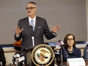 FILE - In this Feb. 2, 2018 file photo, U.S. Attorney for the District of Oregon Billy J. Williams, left, speaks at a marijuana summit in Portland, Ore., as Oregon Gov. Kate Brown sits at right. The U.S. Attorney for Oregon says in a memo that he will prioritize enforcement of marijuana overproduction and interstate trafficking in the state. Williams is the first U.S. attorney to detail his strategy for enforcing federal drug laws in a state where marijuana is legal. The memo released Friday, May 18, 2018, comes three months after Williams convened a summit in Portland to discuss what he calls a "significant overproduction" of marijuana in the state that's driving a black market and illegal trafficking to other states that have not legalized pot.
